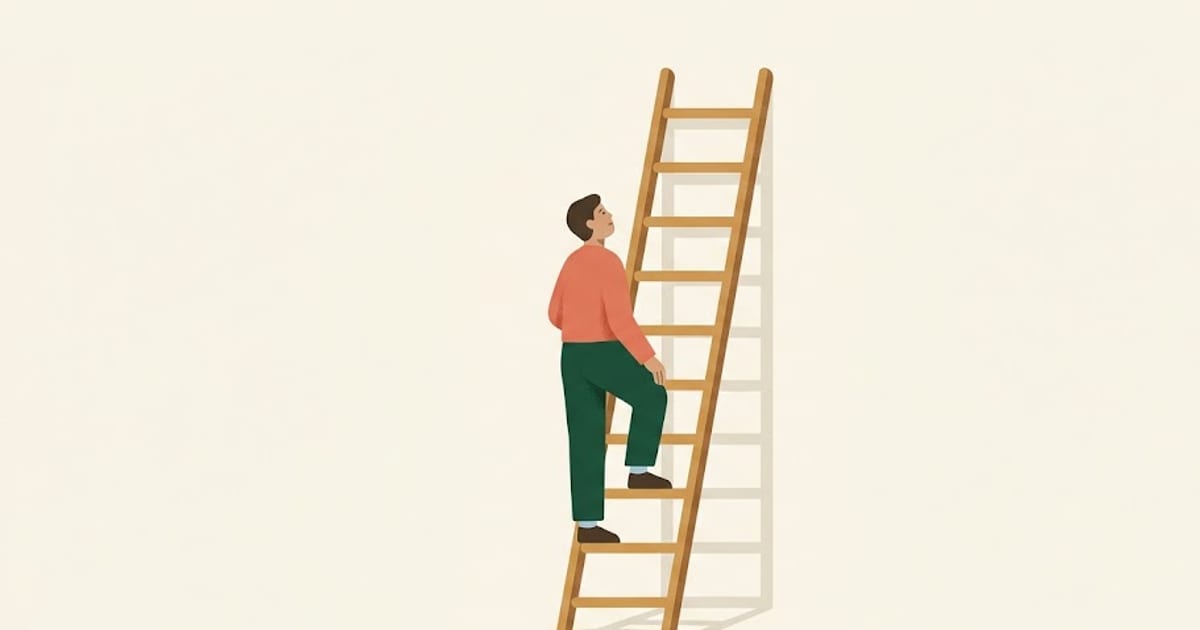 A worker standing on a low rung of a tall ladder